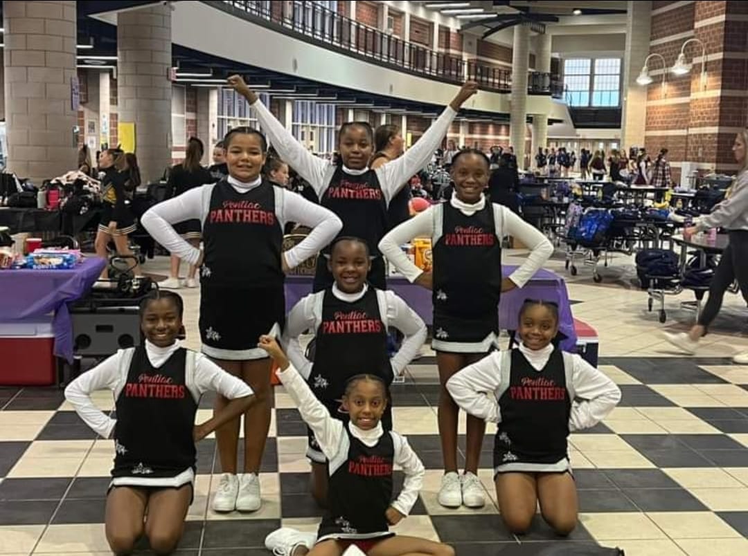 Pontiac Panthers cheerleaders posing together in their Panthers uniforms