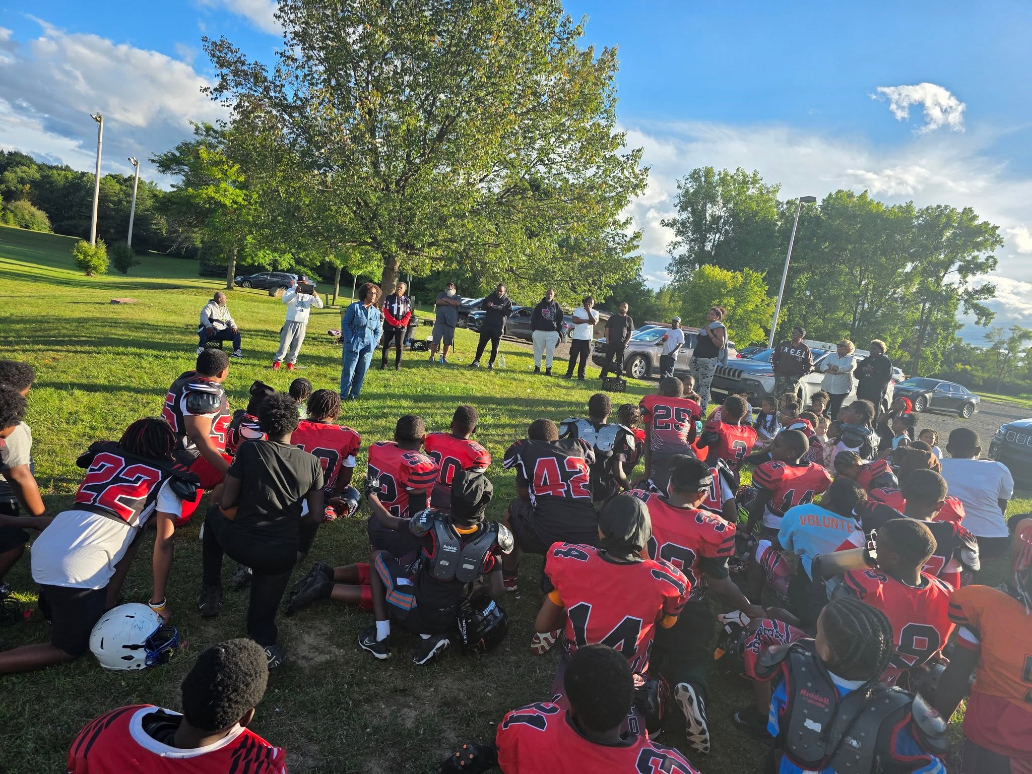Kelly Houston-Johnson speaking to Pontiac Panthers players, coaches, and families